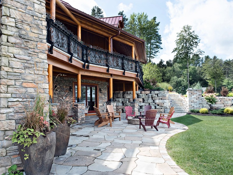 beaver-mountain-log-homes-kuyahoora-lodge-cedar-hybrid-home-stone-patio-1